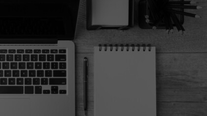 laptop and notepad on a desk