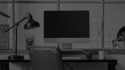 imac computer on a desk with a chair